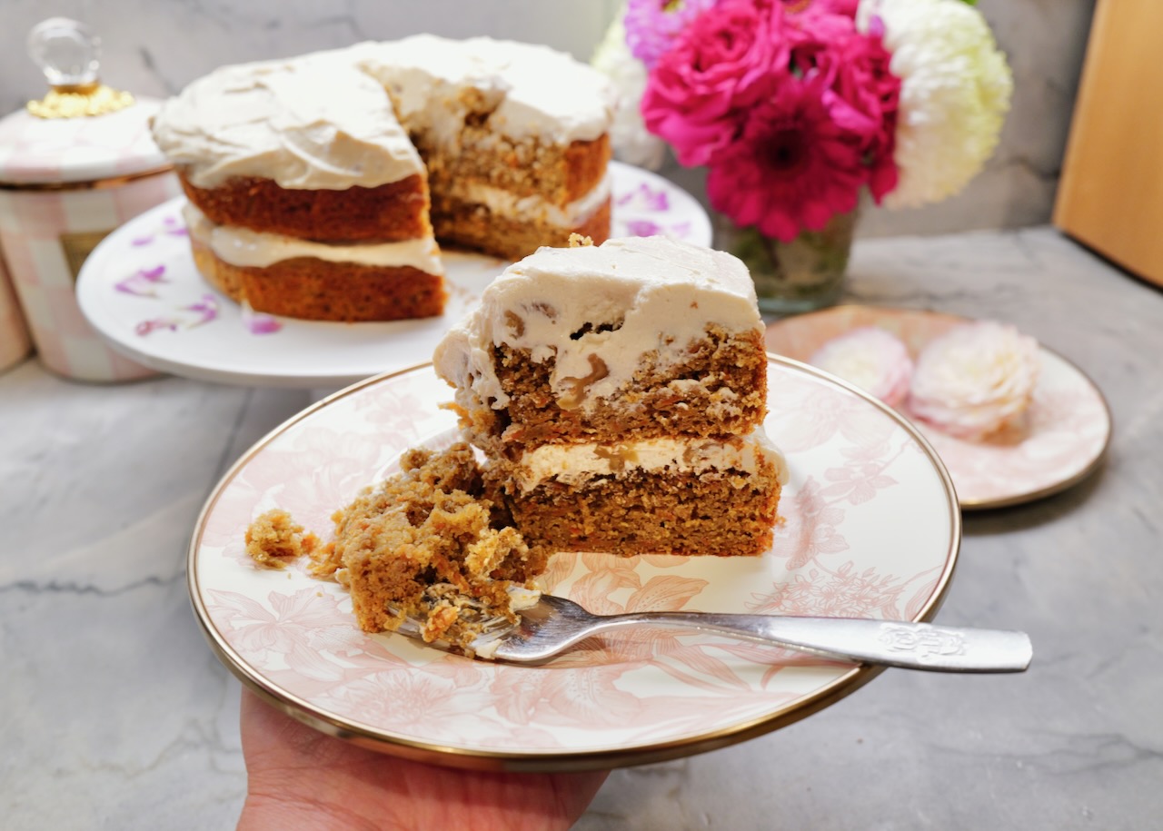 slice of discard carrot cake on a Mackenzie Childs pink plate